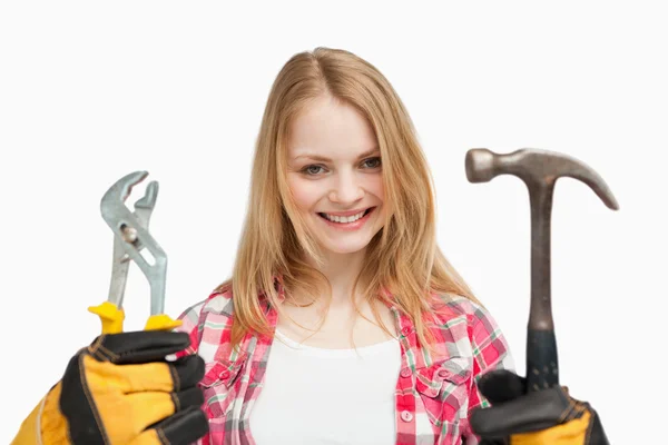 Woman holding tools while standing — Stock Photo, Image