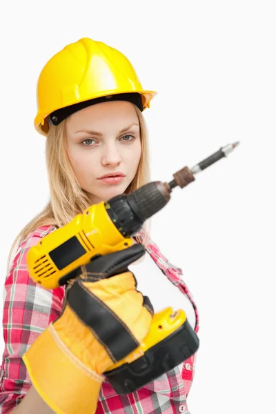 Serious woman holding an electric screwdriver — Stock Photo, Image