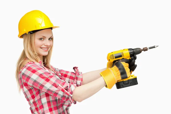 Smiling woman using an electric screwdriver — Stock Photo, Image