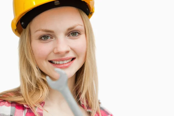 Close up of a woman holding a wrench — Stock Photo, Image