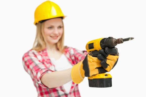 Cheerful woman using an electric screwdriver Stock Photo