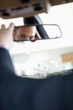 Man adjusting a rear view mirror clipart