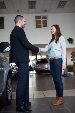 Dealer shaking hand of a woman clipart