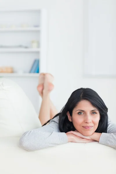 Woman with her head resting on her crossed arms — Stock Photo, Image