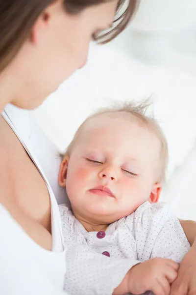 Cute baby sleeping in the arms of her mother — Stock Photo, Image