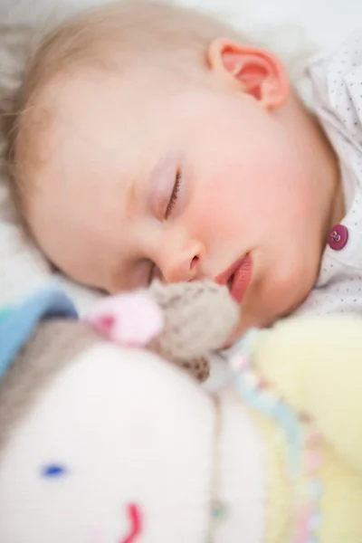 Cute baby sleeping next to her stuffed teddy bear — Stock Photo, Image