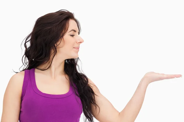 Brunette in purple top looking at her palm — Stock Photo, Image