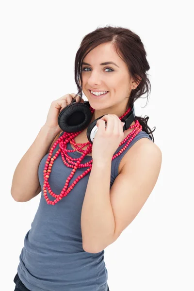 Smiling student holding her headphones — Stock Photo, Image