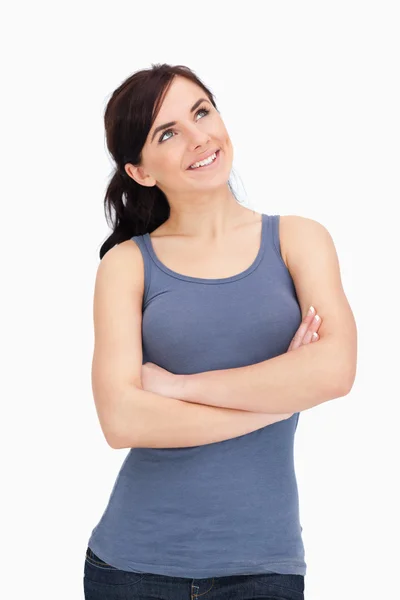 Woman with folded arms looking up — Stock Photo, Image