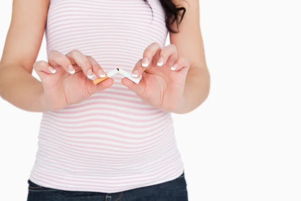 Young pregnant woman breaking a cigarette — Stock Photo, Image