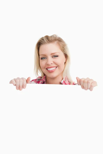 Happy woman holding a blank placard — Stock Photo, Image