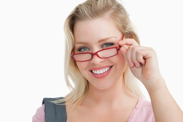 Mujer joven feliz sosteniendo gafas rojas — Foto de Stock