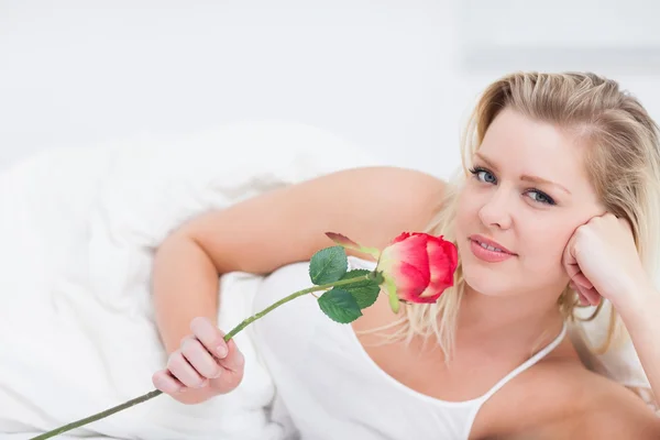 Young woman holding a pink rose — Stock Photo, Image