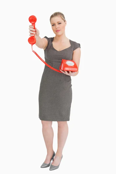 Mujer sosteniendo un teléfono rojo — Foto de Stock