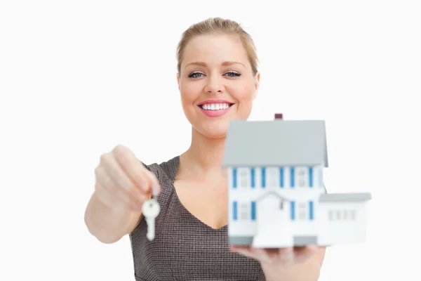 Model house and a key holding by a woman — Stock Photo, Image