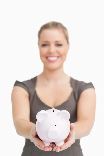 Woman showing a piggy bank — Stock Photo, Image