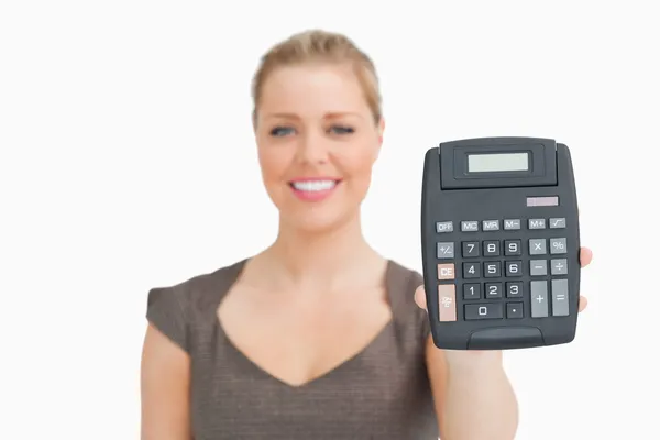 Woman showing a calculator in her hand — Stock Photo, Image