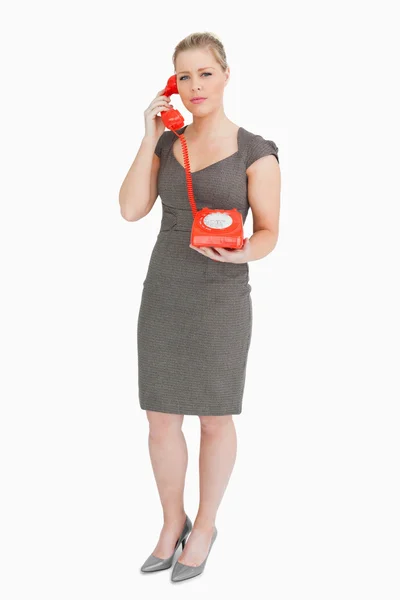 Serious woman calling with a retro phone — Stock Photo, Image