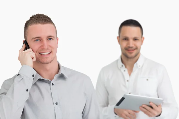 Two men with phone and tablet computer — Stock Photo, Image