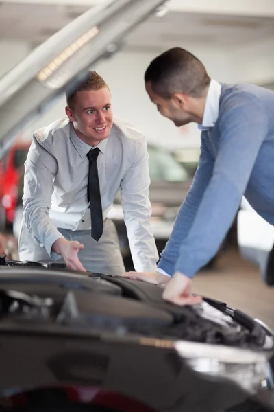 Two men looking at a car engine — Stock Photo, Image