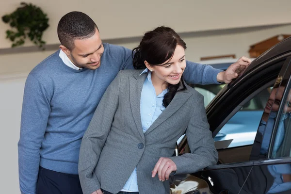 Lachende paar op zoek in een auto — Stockfoto