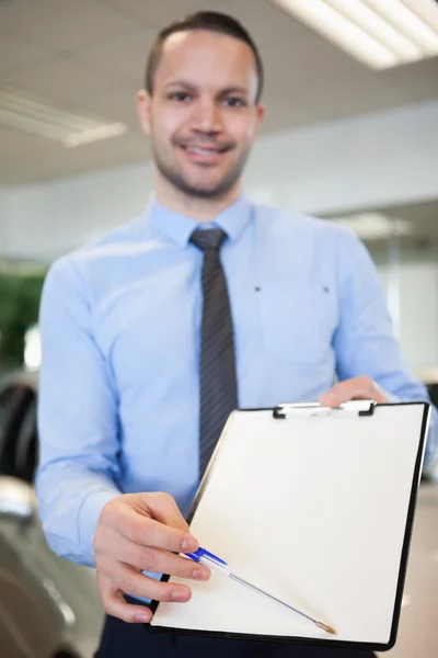 Salesman holding a contract — Stock Photo, Image