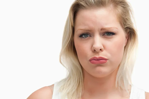 Upset blonde woman staring at the camera Royalty Free Stock Images