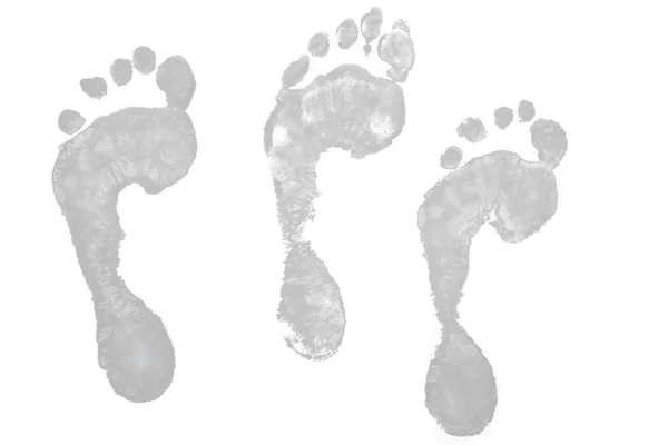 Drie grijs voetafdrukken — Stockfoto