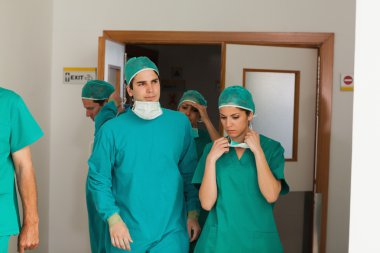 Surgery team leaving the operating room clipart