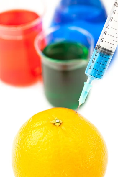 Syringe pricking a lemon — Stock Photo, Image