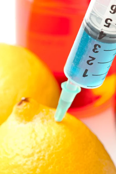 Close up of syringe into a lemon — Stock Photo, Image