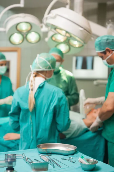 Surgical tools displayed while a surgical team is working — Stock Photo, Image