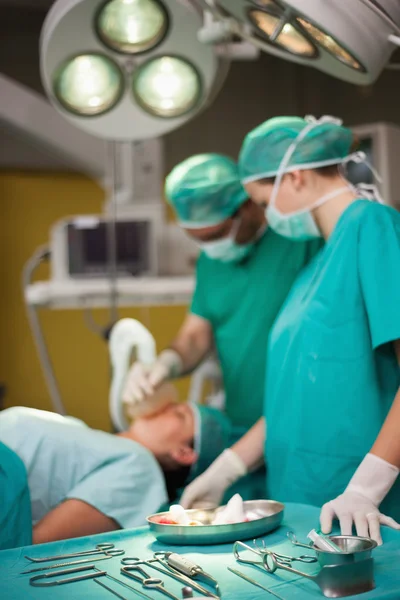 Surgical trolley and surgeons — Stock Photo, Image