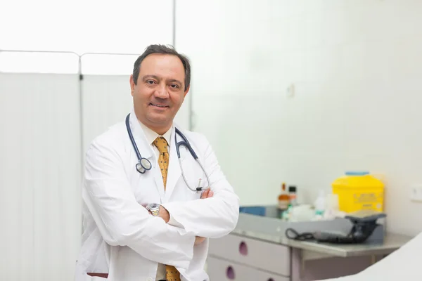 Doctor sonriendo mientras dobla los brazos —  Fotos de Stock