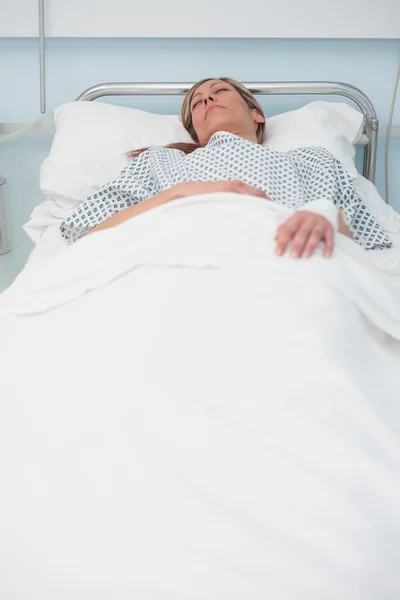 Woman sleeping on a bed — Stock Photo, Image