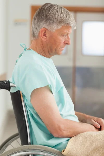 Sad man sitting in a wheelchair — Stock Photo, Image