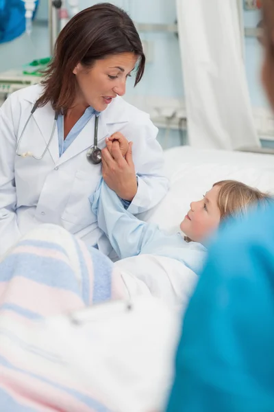 Doctor sitting next to a child — Stock Photo, Image