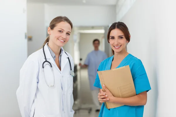 Doctor and a nurse standing side by side in a hallway Royalty Free Stock Images