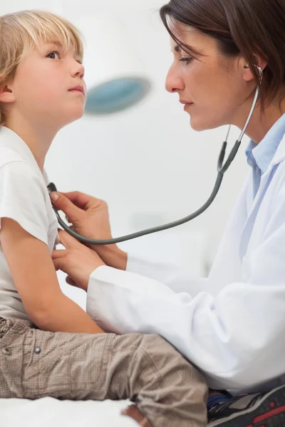 Child being auscultating by a doctor Stock Photo