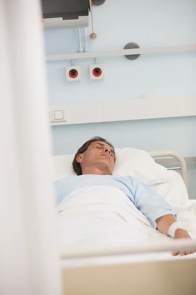 Asleep patient on a bed — Stock Photo, Image