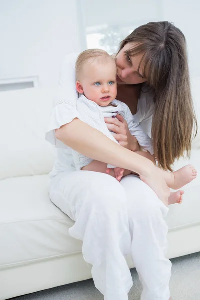 Baby sitting on his mother knees — Stock Photo, Image
