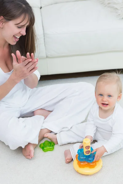 Baby sitting on the floor while playing — Stock Photo, Image