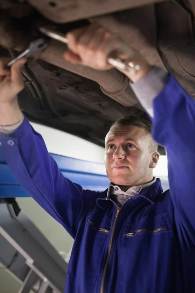 Concentrated mechanic repairing with tools — Stock Photo, Image