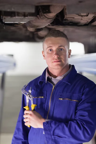 Mechanic holding an adjustable pliers — Stock Photo, Image