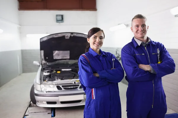 Smiling mechanics with arms crossed — Stock Photo, Image
