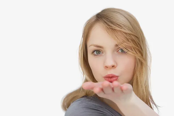 Blonde woman blowing on her hand — Stock Photo, Image