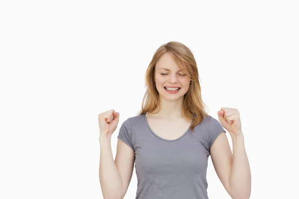 Woman clenching one's fists with closed eyes — Stock Photo, Image