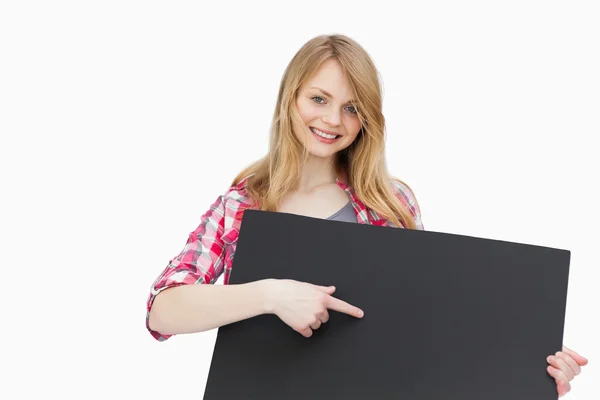 Woman showing a black board with her finger — Stock Photo, Image