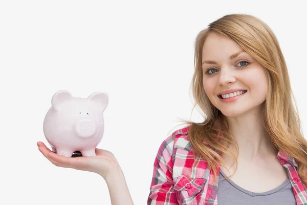 Woman holding a piggy bank on her hand — Stock Photo, Image