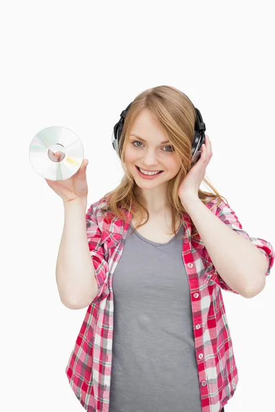 Woman standing while holding a cd — Stock Photo, Image